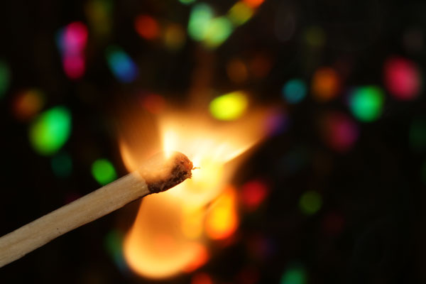 Lit match with flame, representing The Spark concept in Lifestyle Inertia Design where initial inspiration must be sustained through daily practice