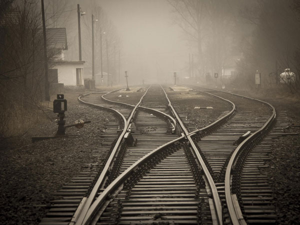 Railroad track splitting into two paths, representing the Quickstop technique redirecting you from distraction to productive action